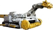 A tracked machine with a grey body and a yellow cutting head on a raised boom.