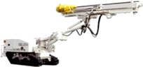 A drilling rig on crawler tracks, its white boom carrying a yellow drill feed.